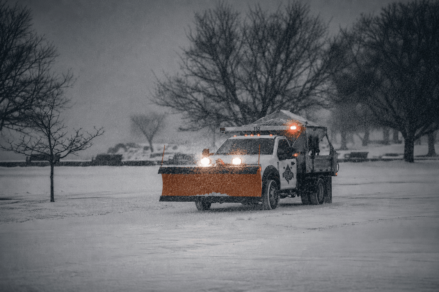 Eco-Ace snow plow service vehicle in a winter storm.